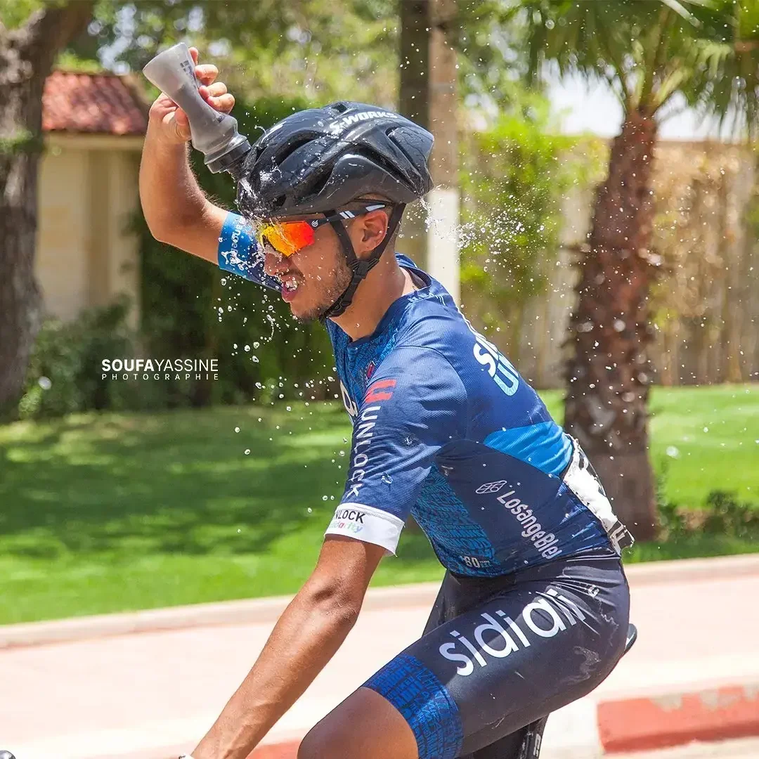 Sidi Ali cyclist cooling down with water during a race